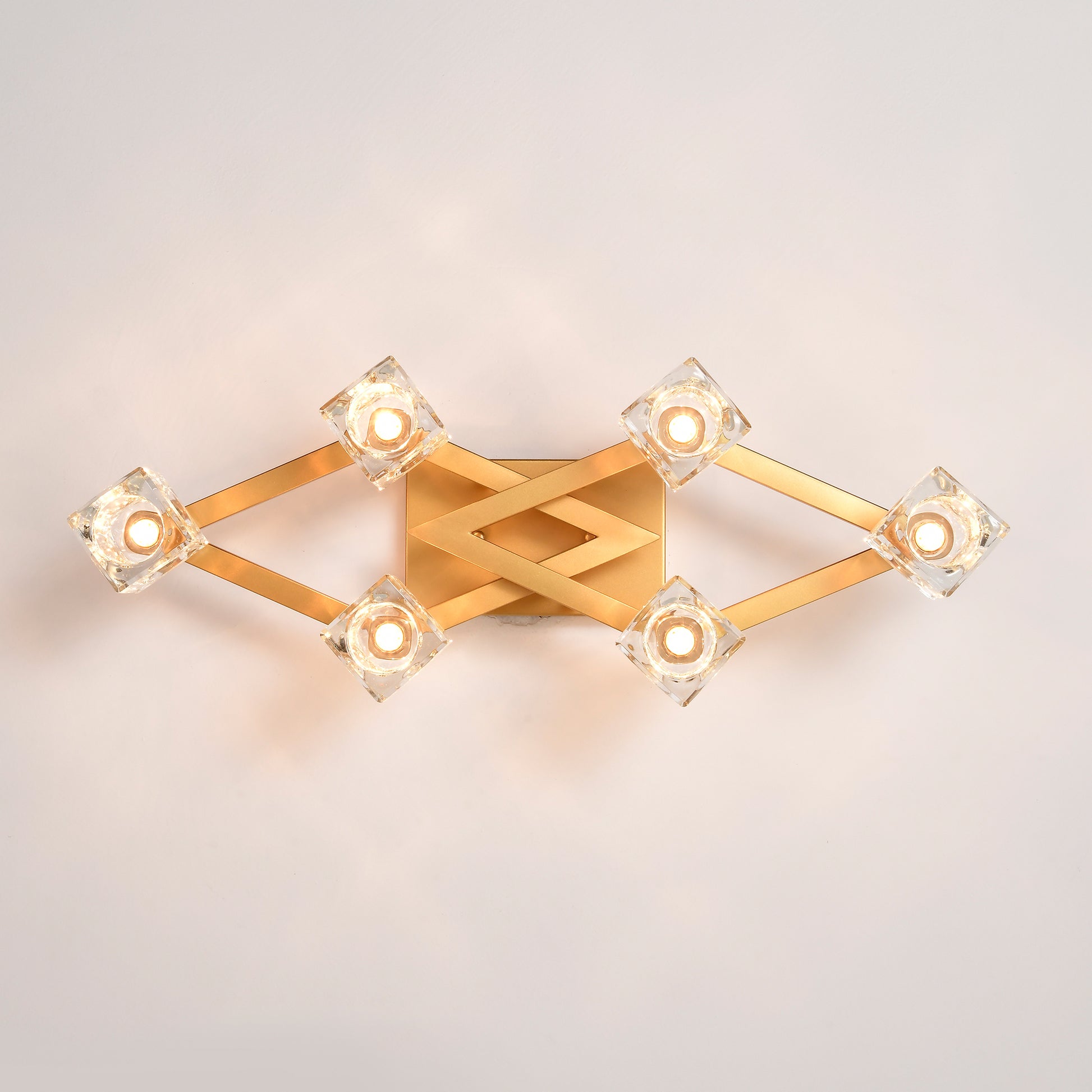 Modern gold wall sconce with diamondshaped crystal accents
