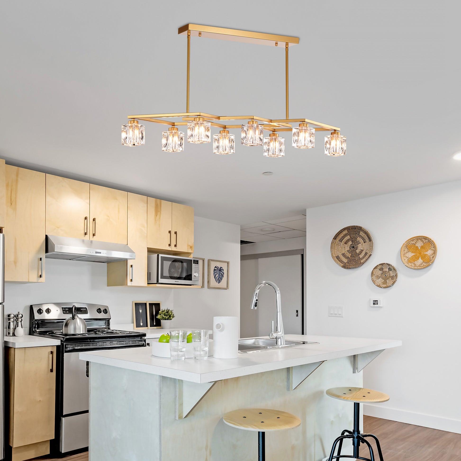 Gold rectangular chandelier with crystal accents above kitchen island