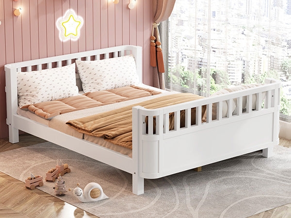 White wooden toddler bed with slatted headboard and footboard