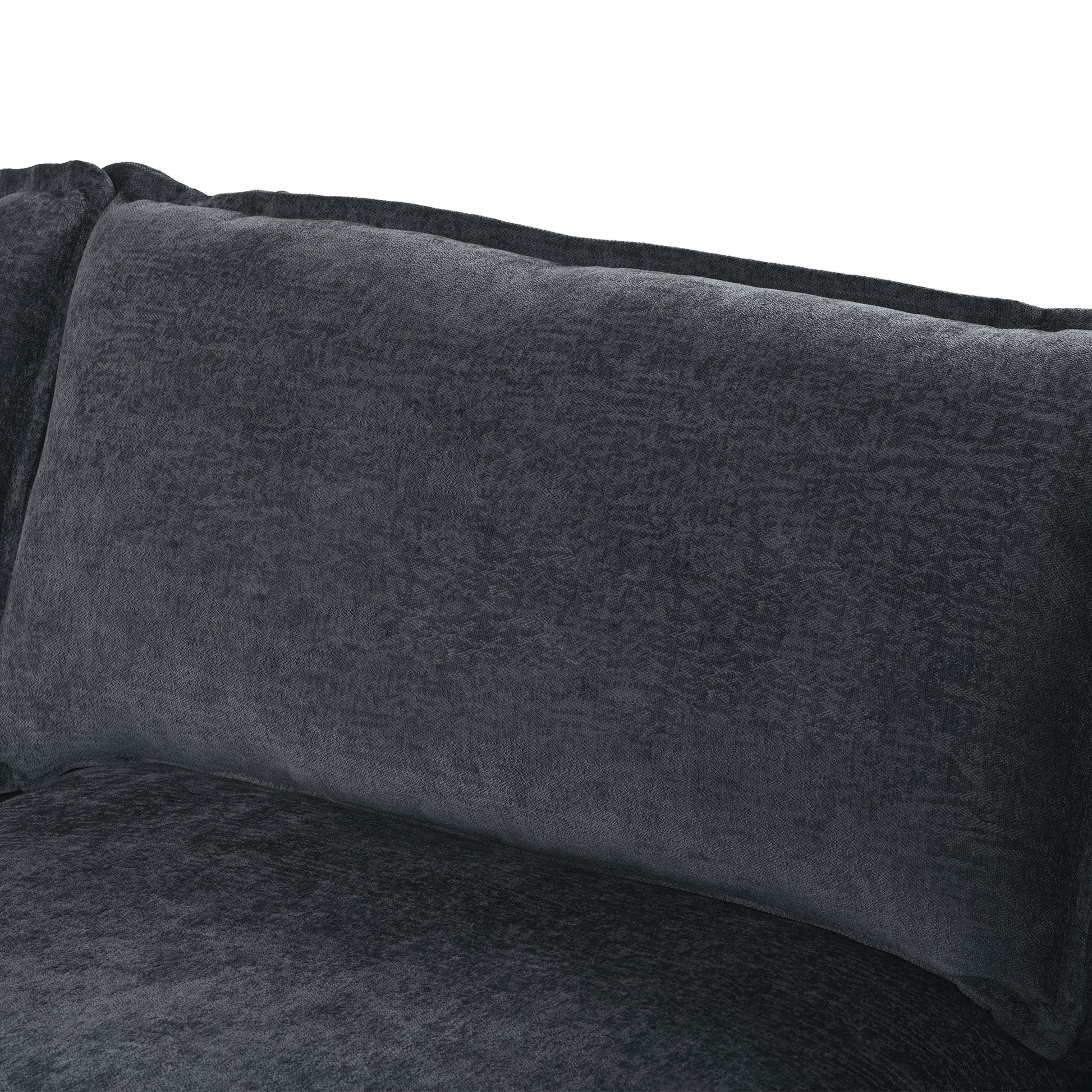 Closeup of a plush charcoal grey velvet sofa cushion