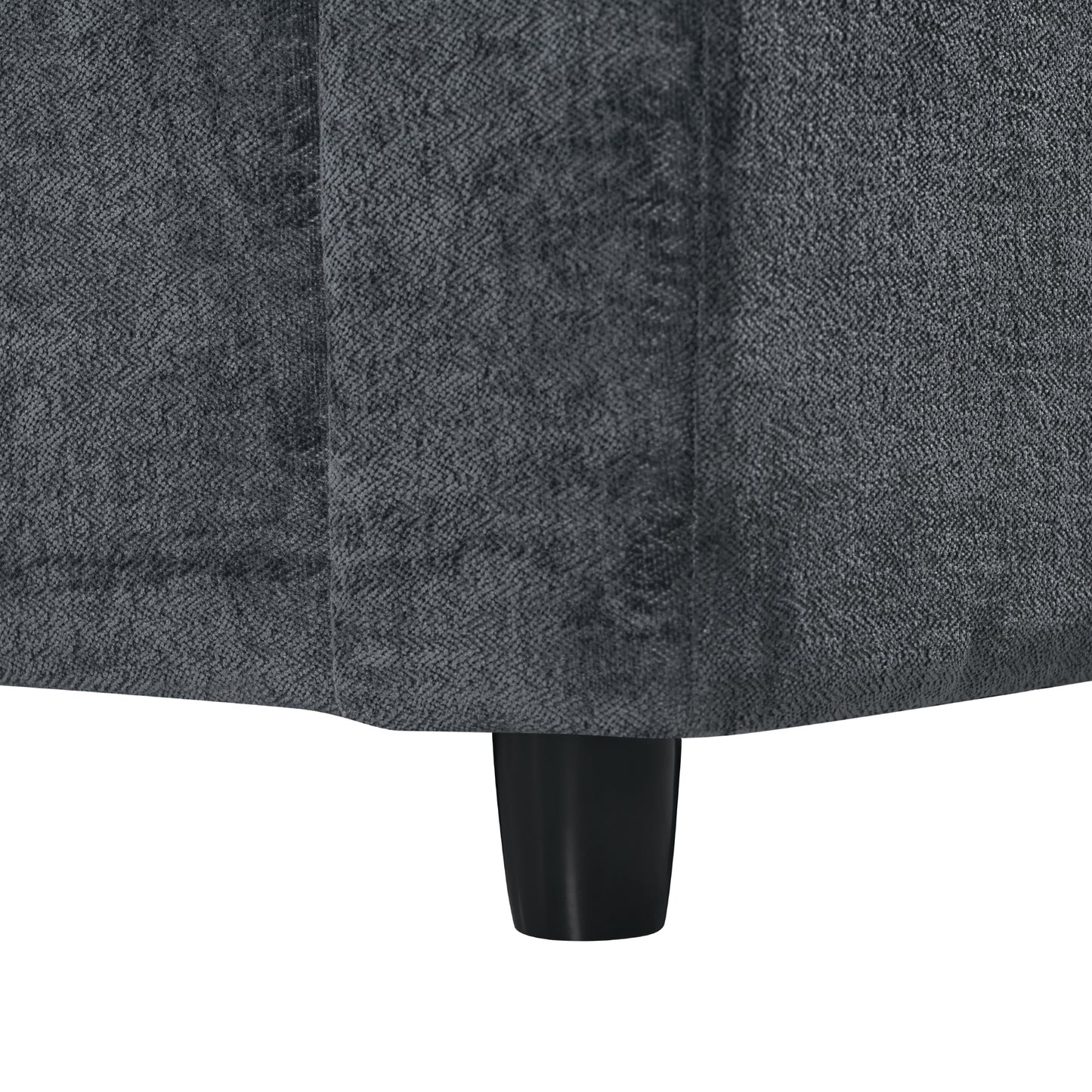 Dark grey herringbone textured fabric sofa detail with a black tapered leg