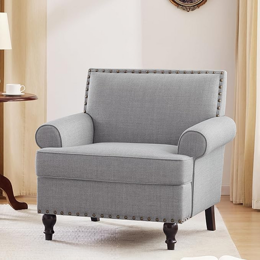 Grey fabric armchair with rolled arms and nailhead trim
