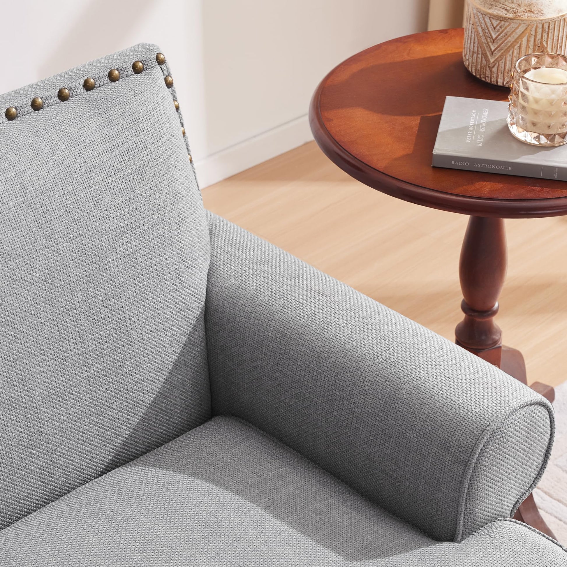 Gray fabric armchair with brass nailhead trim