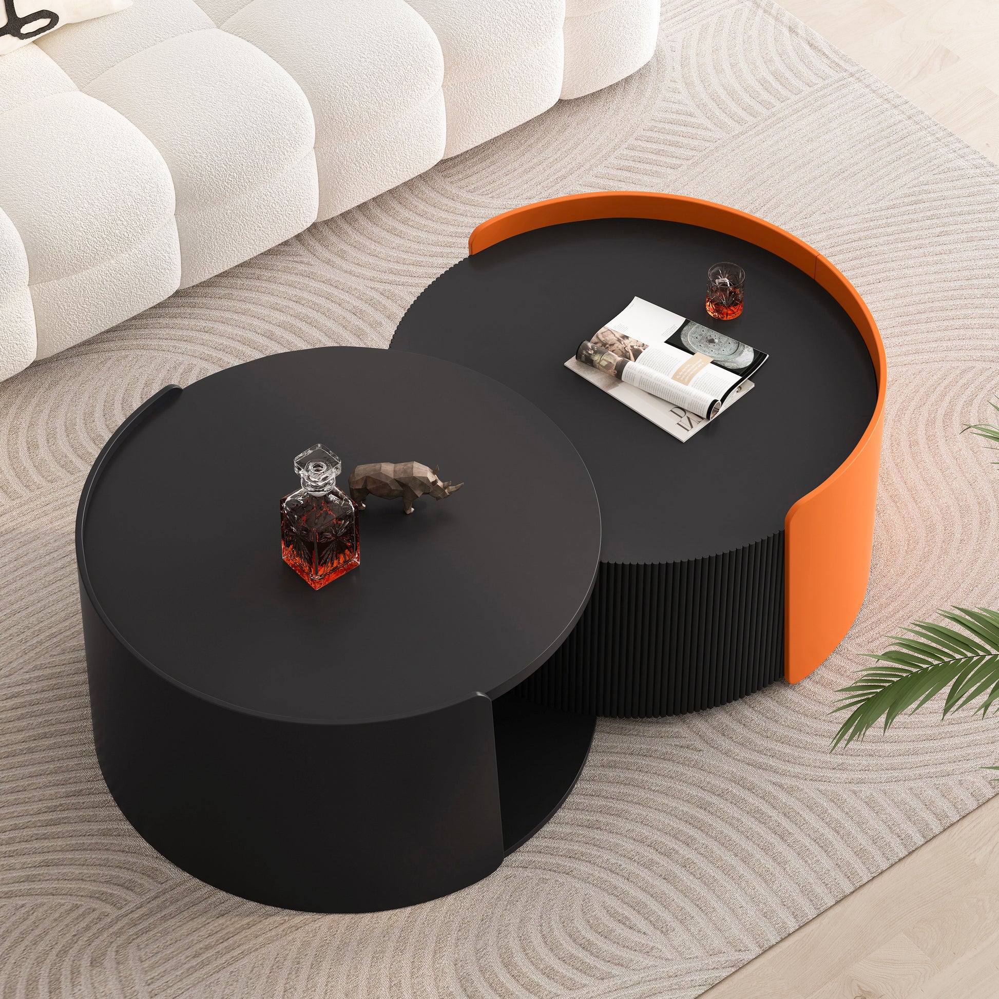 Modern black nesting coffee table with orange accent on rug