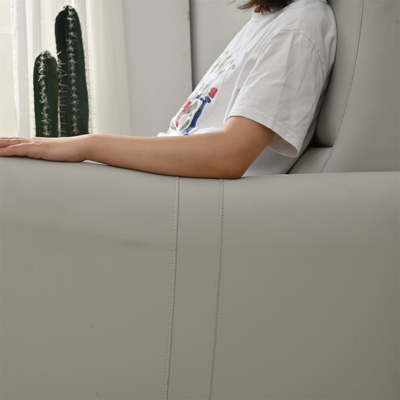 Light grey leather couch detail with stitching