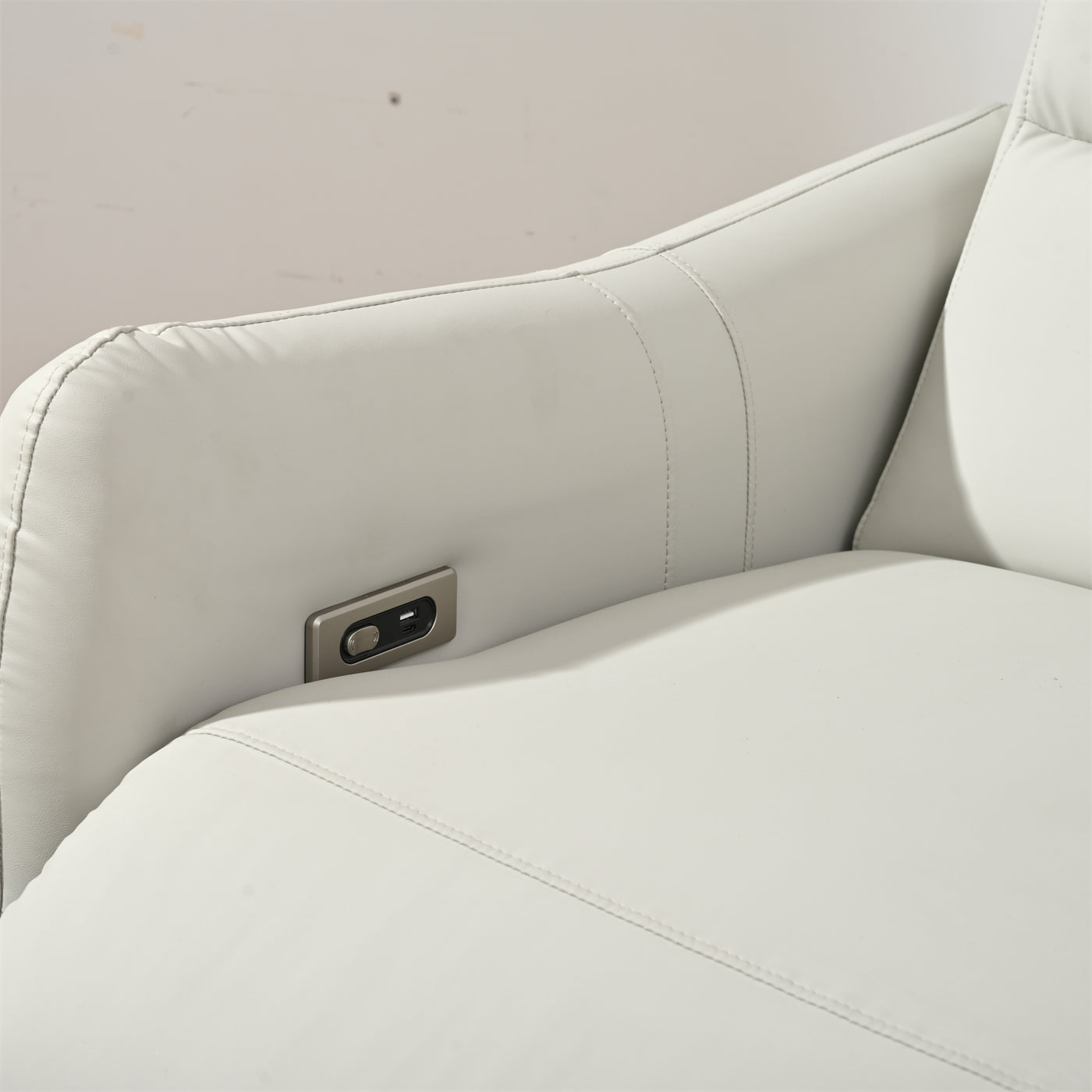 White leather recliner armrest with integrated USB charging port