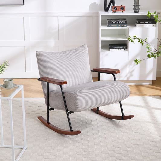 Light gray corduroy rocking chair with wooden armrests and dark metal frame