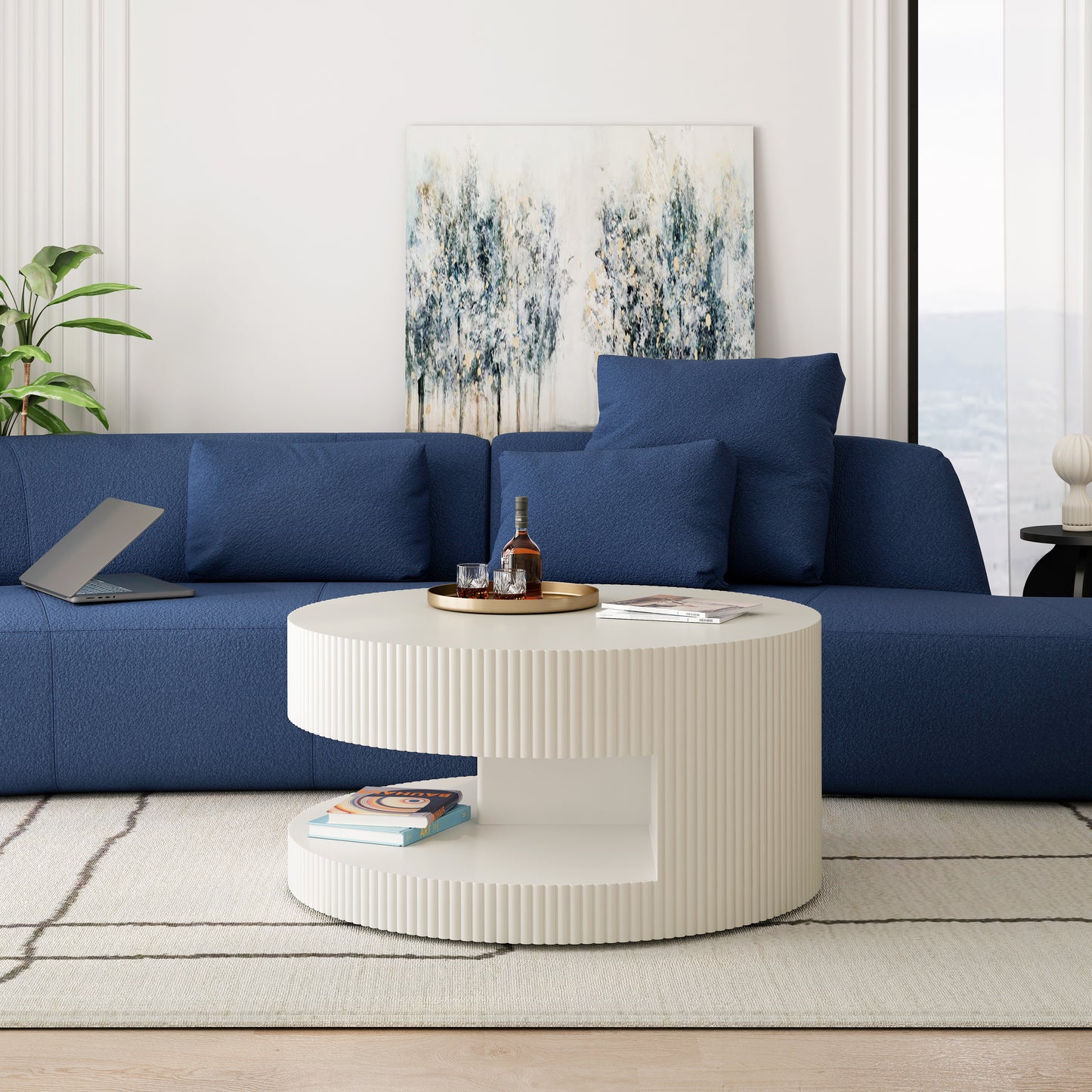 Dark blue textured sectional sofa with lumbar pillows and a laptop