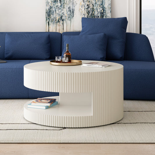 Round fluted cream coffee table with books and drinks