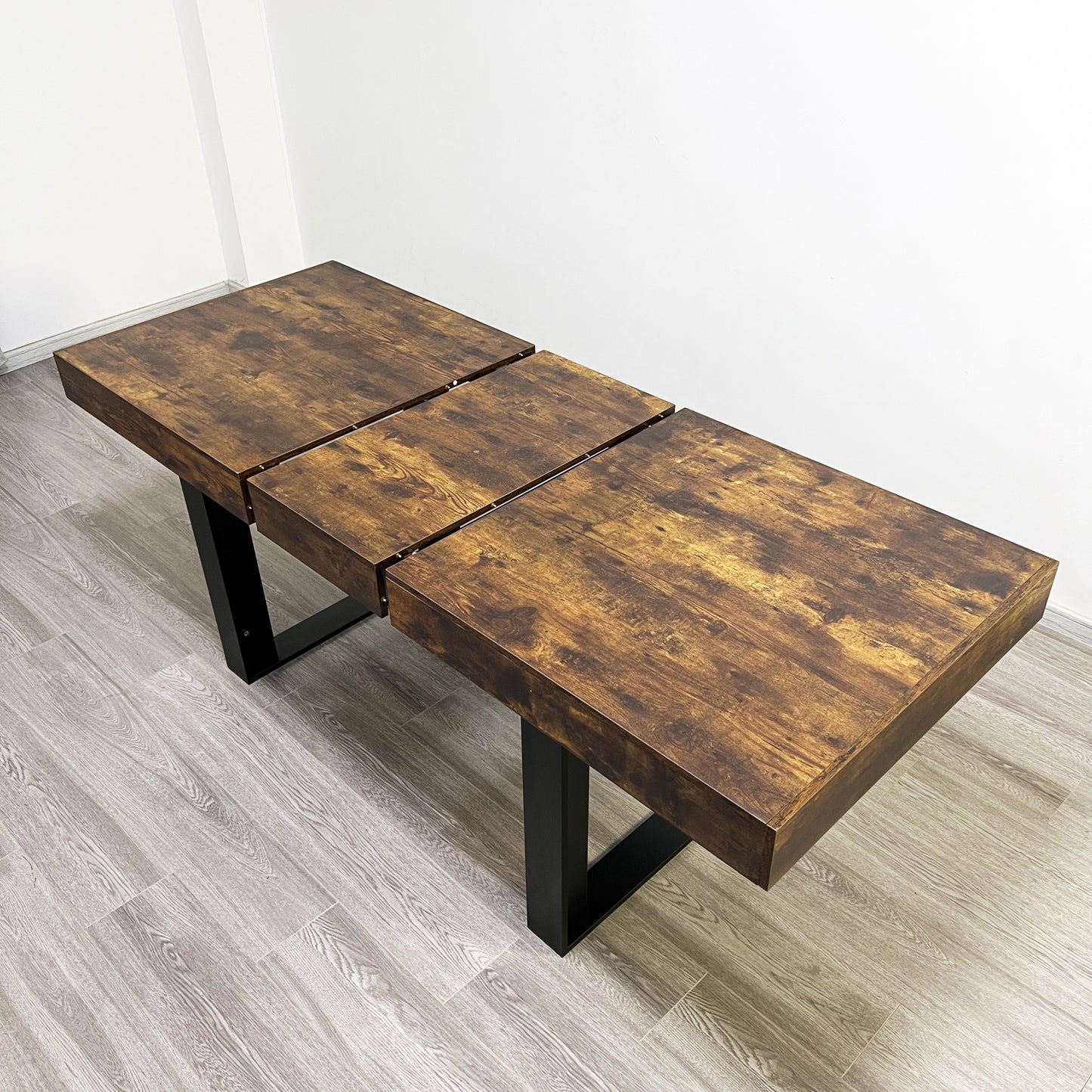 Rustic wooden dining table with expandable leaf design and black metal legs
