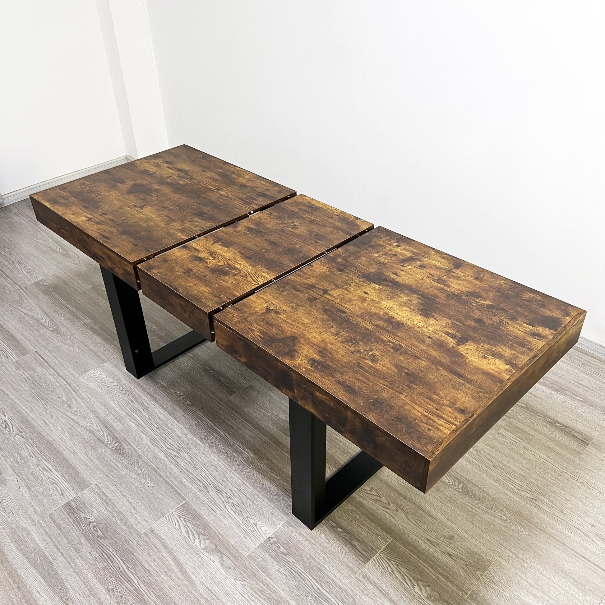 Rustic wooden dining table with expandable leaf design and black metal legs