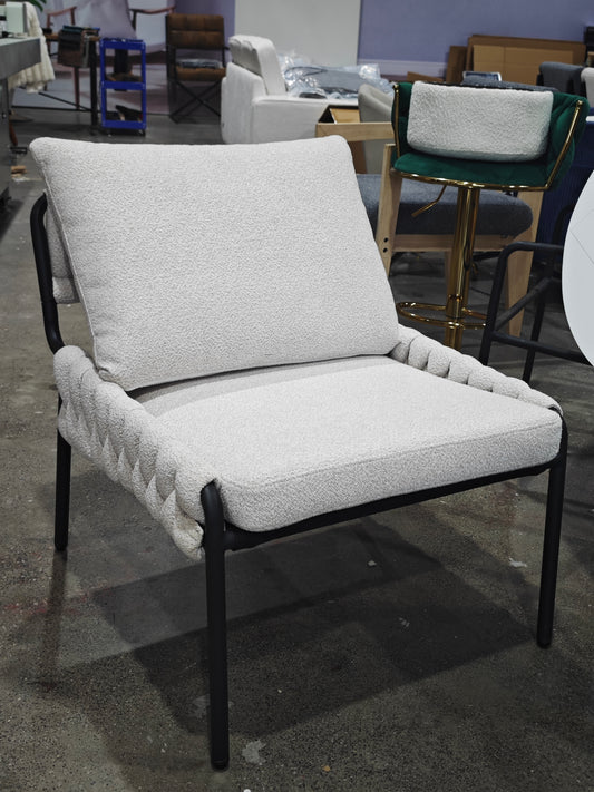 Cream boucle armchair with black metal legs and braided armrests