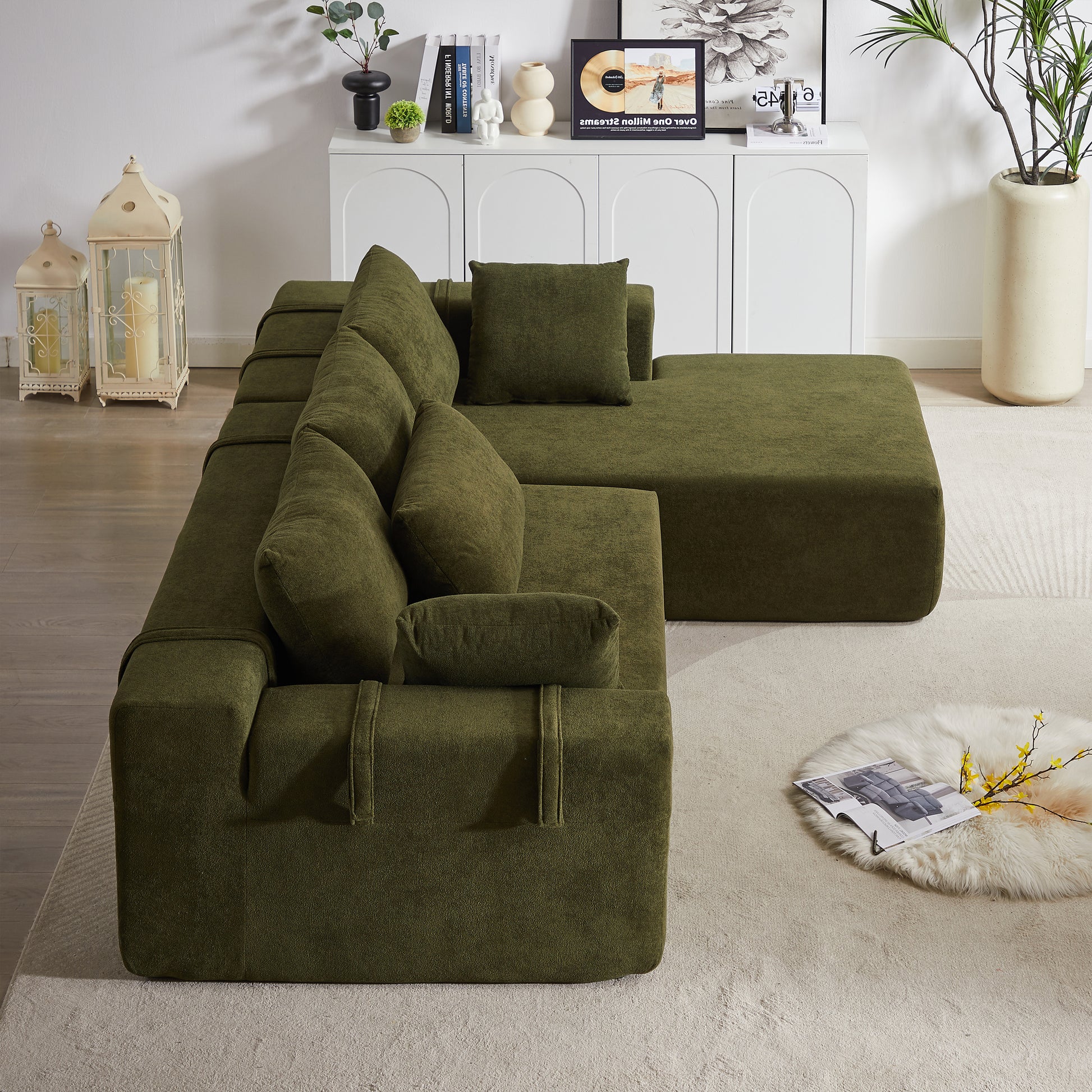 Deep green modular sectional sofa with plush cushions and piped detailing perfect for modern living rooms