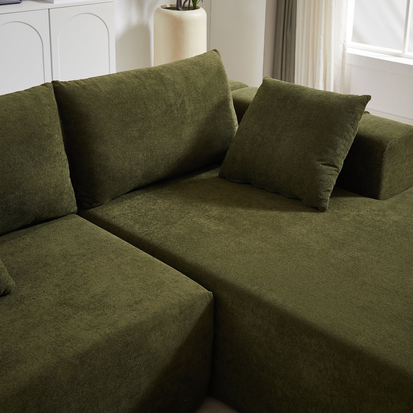 Olive green sectional sofa with textured fabric and plush cushions