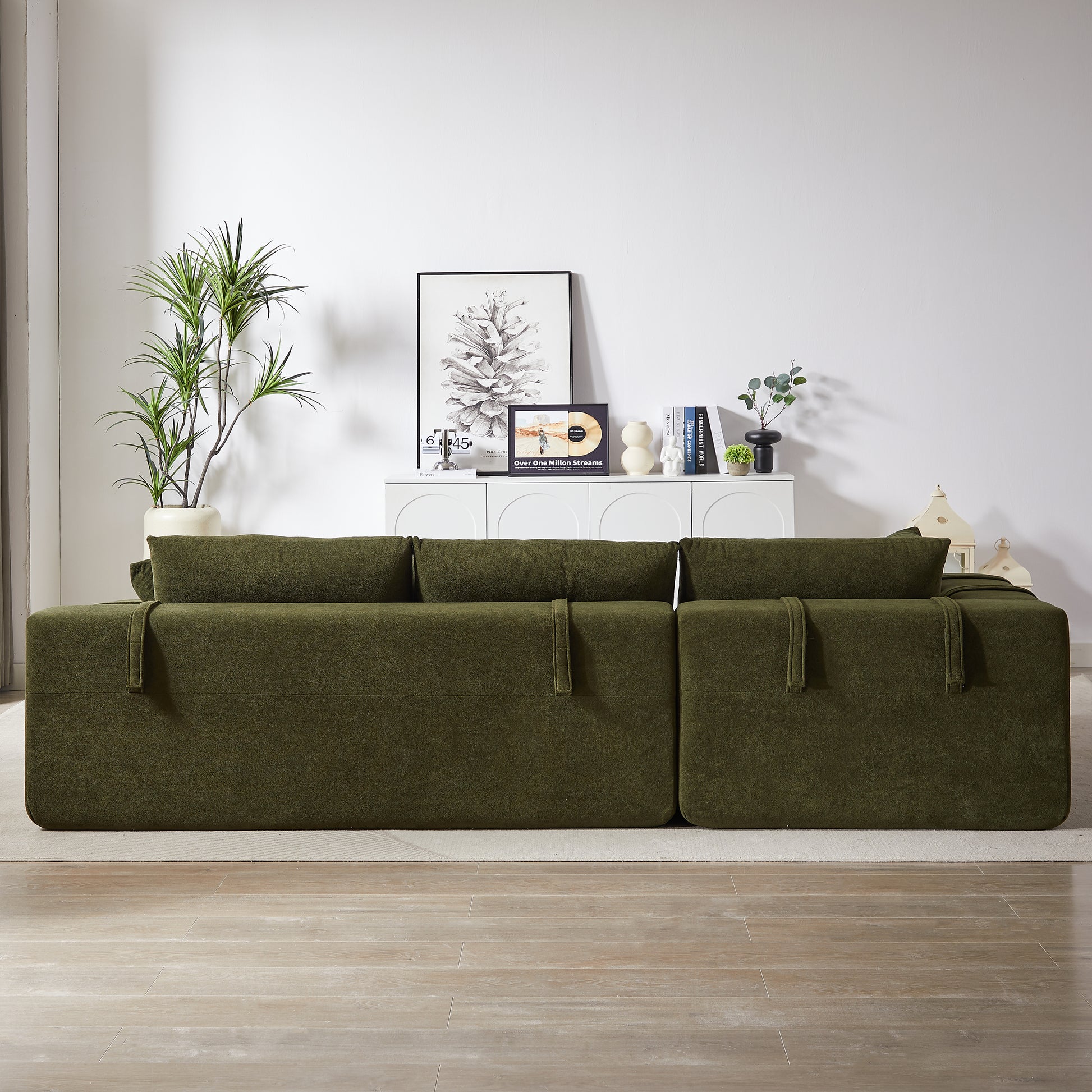 Deep green modular sofa with plush cushions