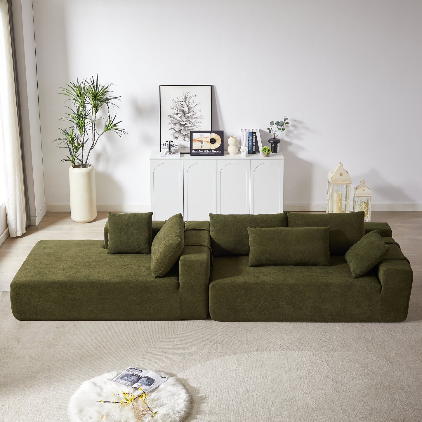 Modular green velvet sofa with deep seat cushions and plush pillows