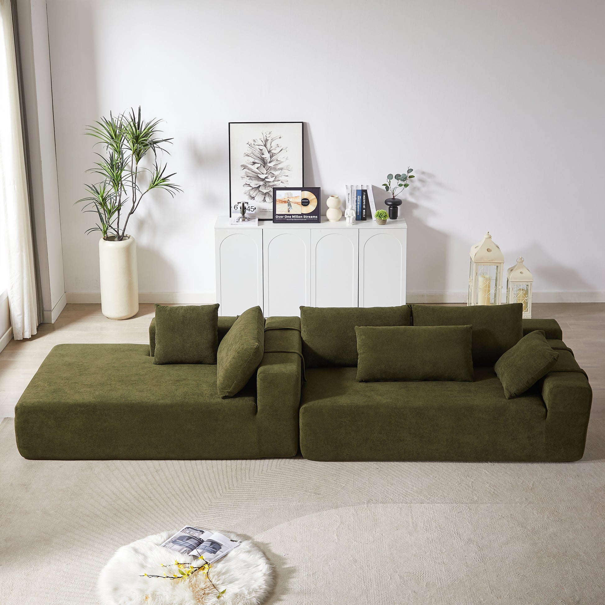 Modular green velvet sofa with deep seat cushions and plush pillows