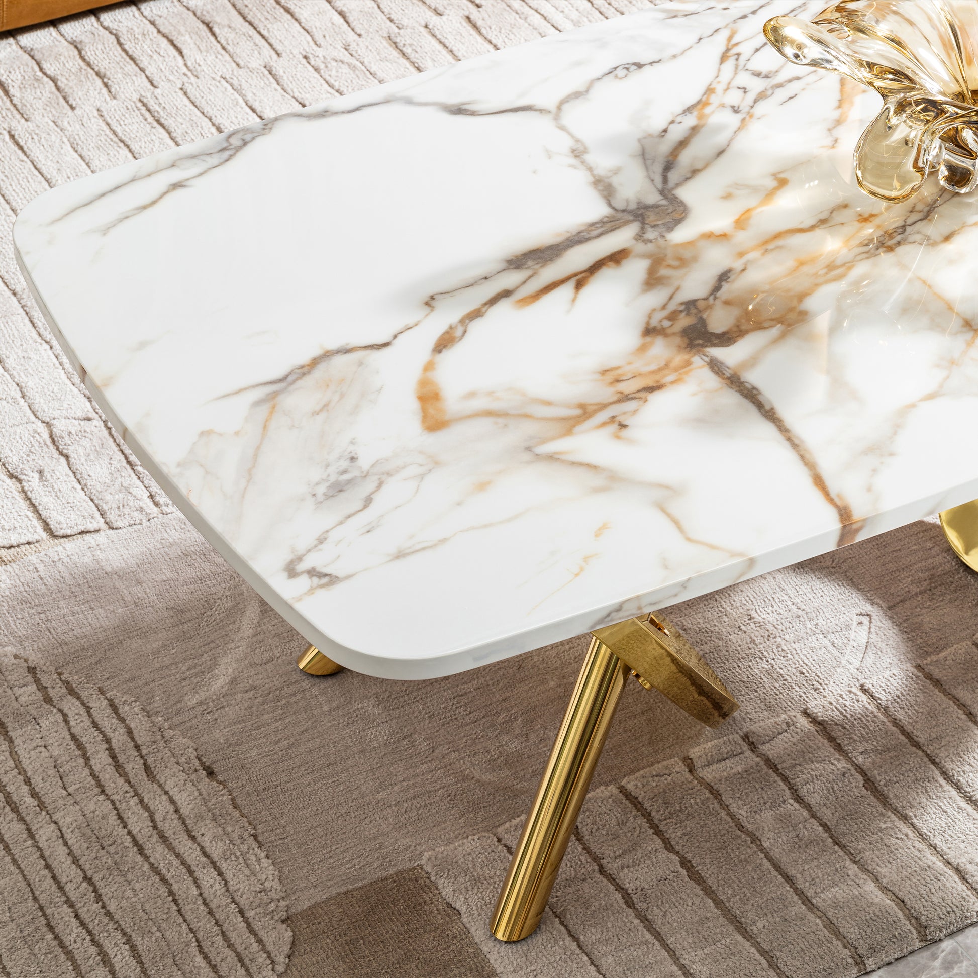 White marble coffee table with gold legs and intricate veining