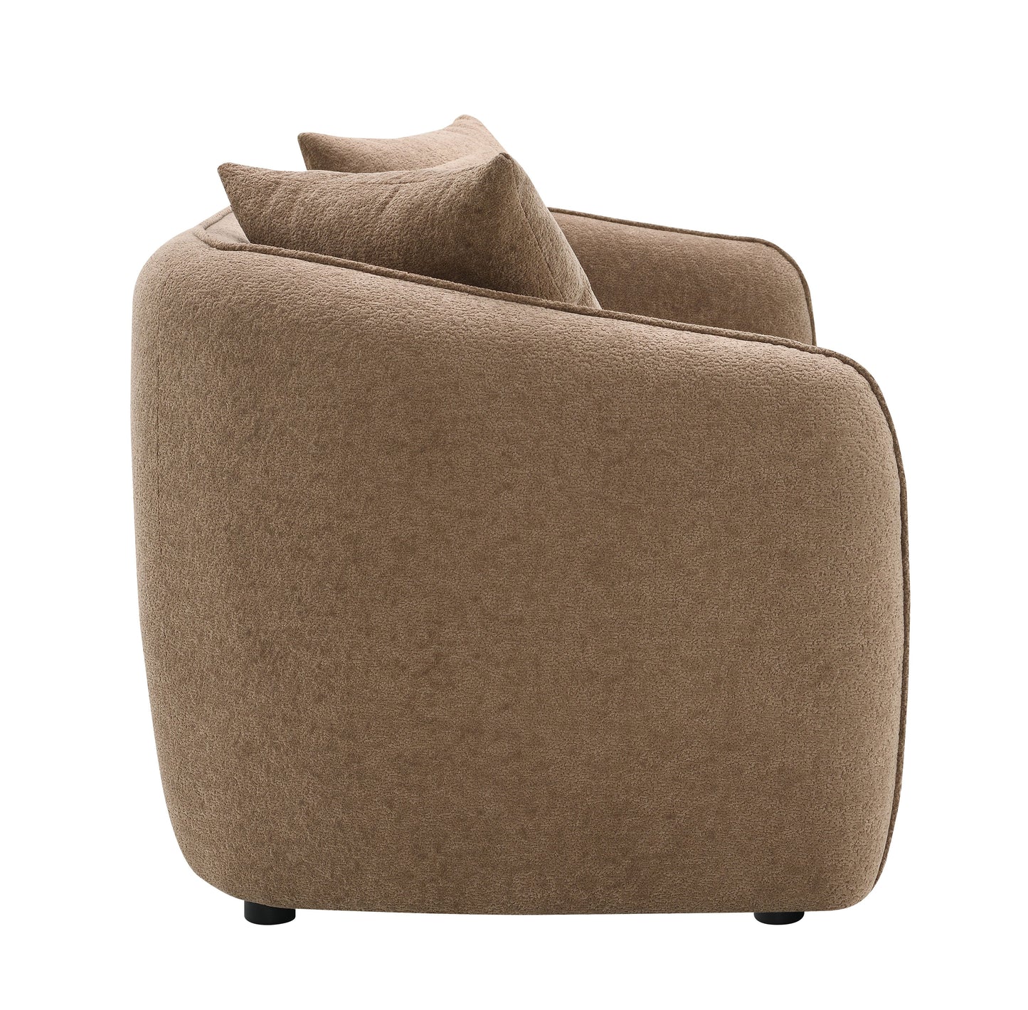 Plush brown accent chair with curved back and two matching throw pillows