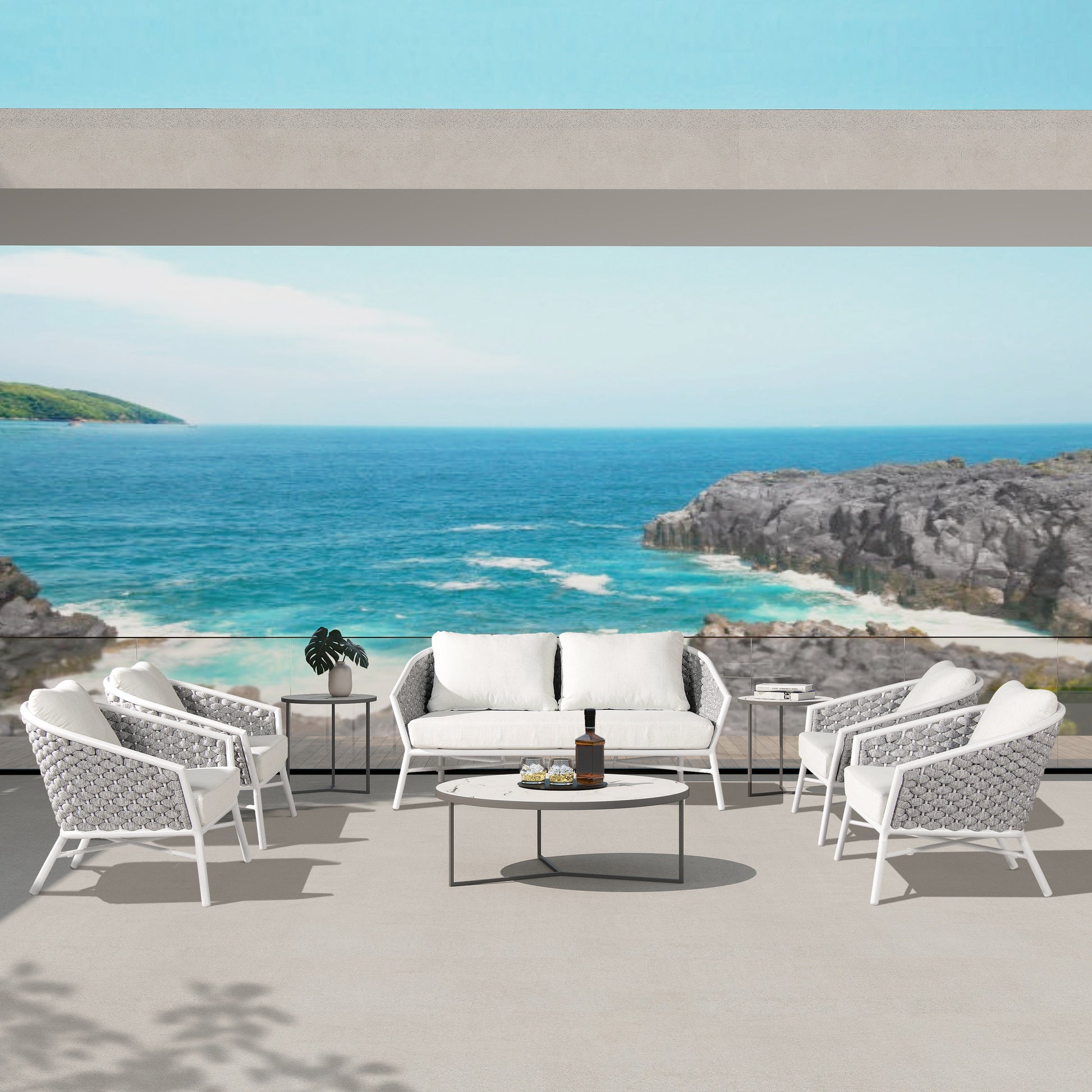 White cushioned outdoor sofa set with woven grey accents and a coffee table