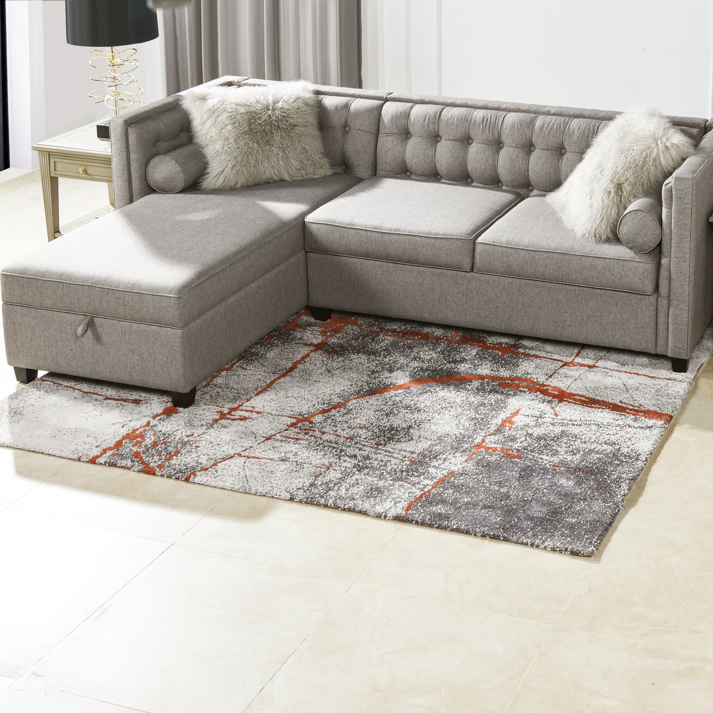 Tufted gray sectional sofa with chaise lounge and decorative pillows