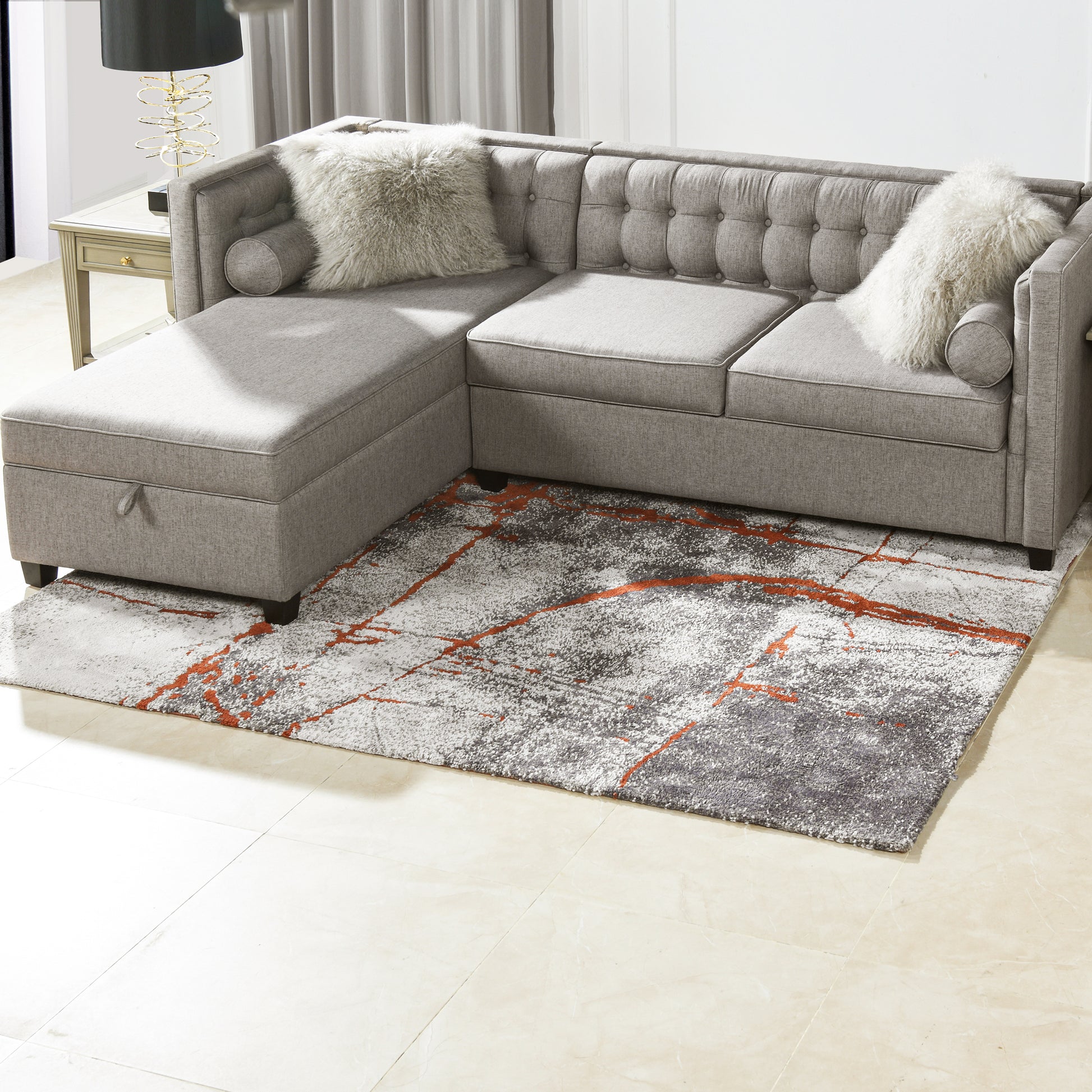 Tufted gray sectional sofa with chaise lounge and decorative pillows