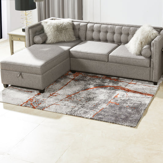 Tufted gray sectional sofa with chaise lounge and decorative pillows