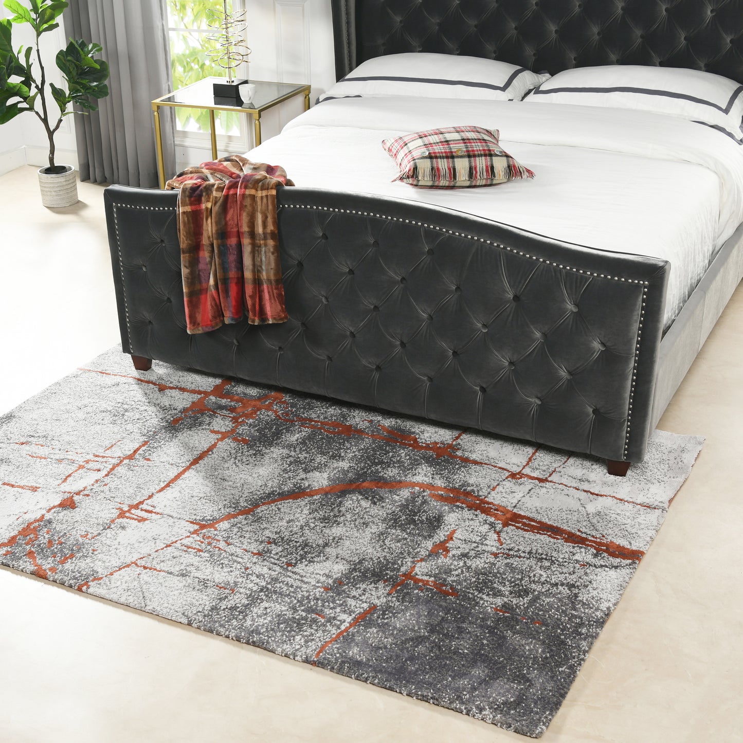 Tufted charcoal gray velvet bed frame with silver nailhead trim