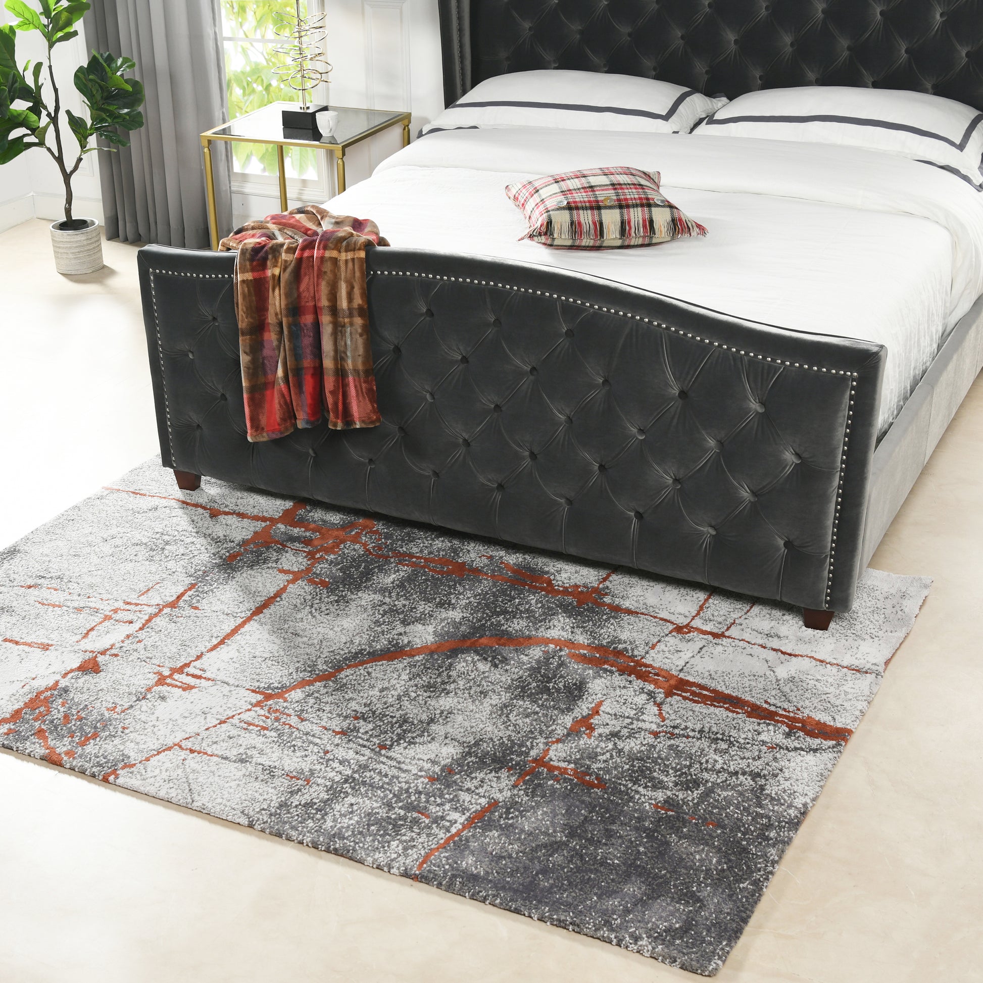 Tufted charcoal gray velvet bed frame with silver nailhead trim