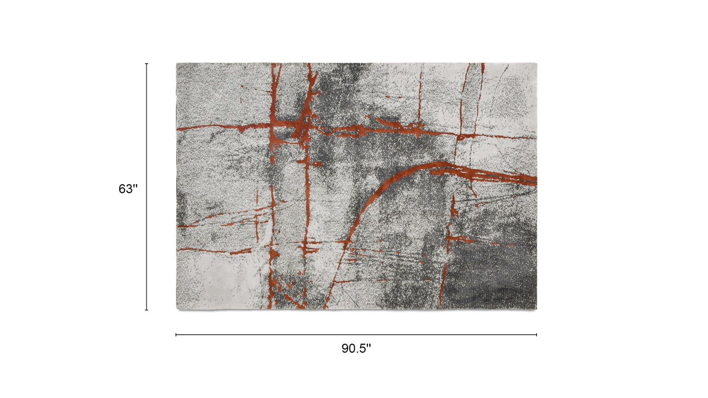 Gray and white abstract area rug with abstract orange lines