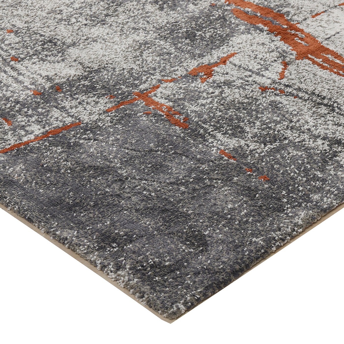 Closeup of a grey abstract area rug with orange accents