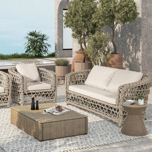Woven wicker outdoor sofa set with cream cushions and a rectangular coffee table