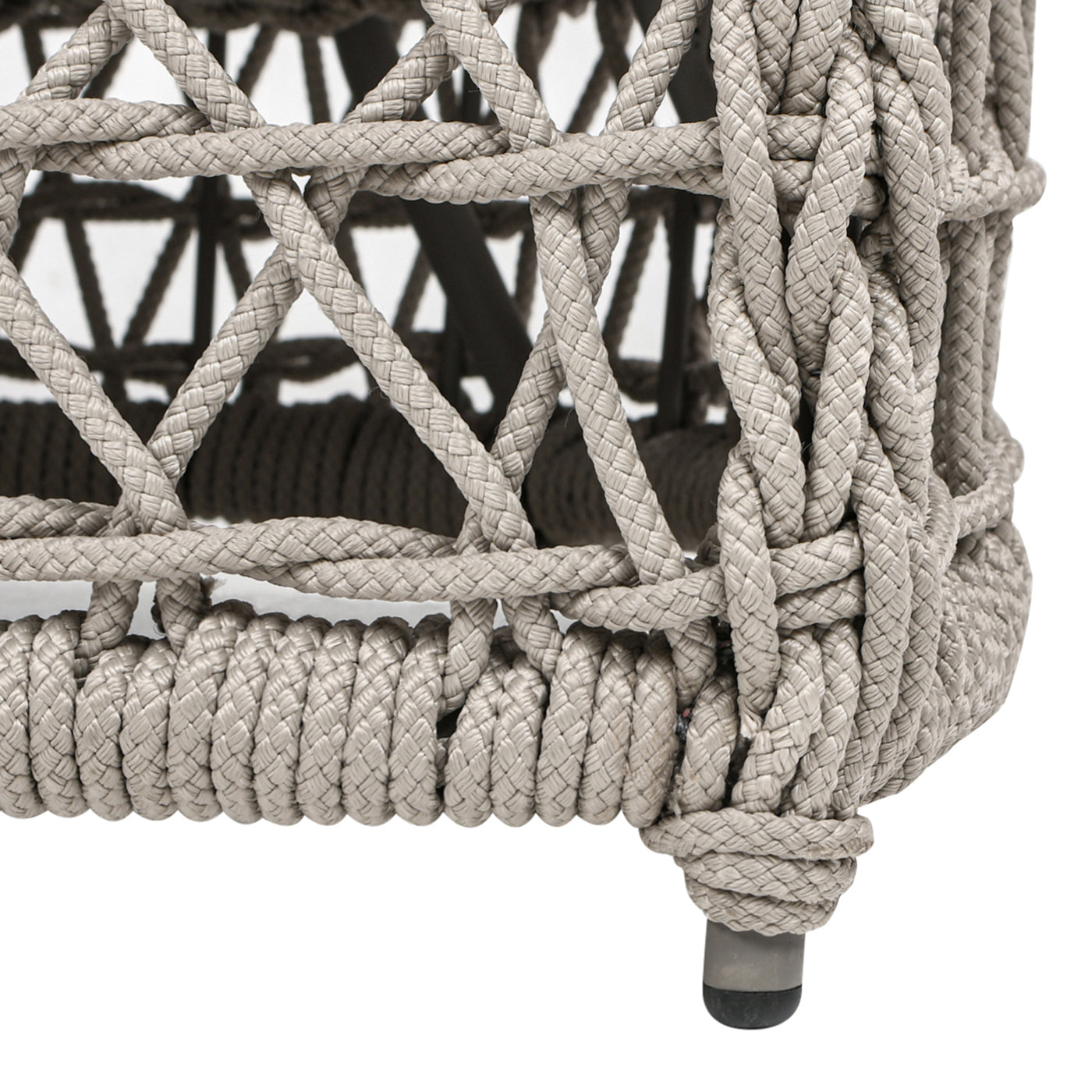 Closeup of a grey ropewrapped outdoor chair leg with woven diamond pattern
