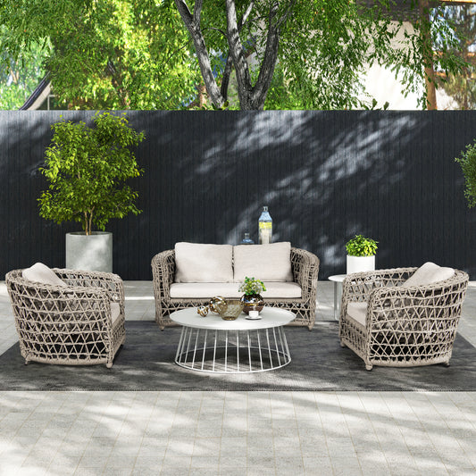 Woven rattan patio furniture set with beige cushions and white coffee table