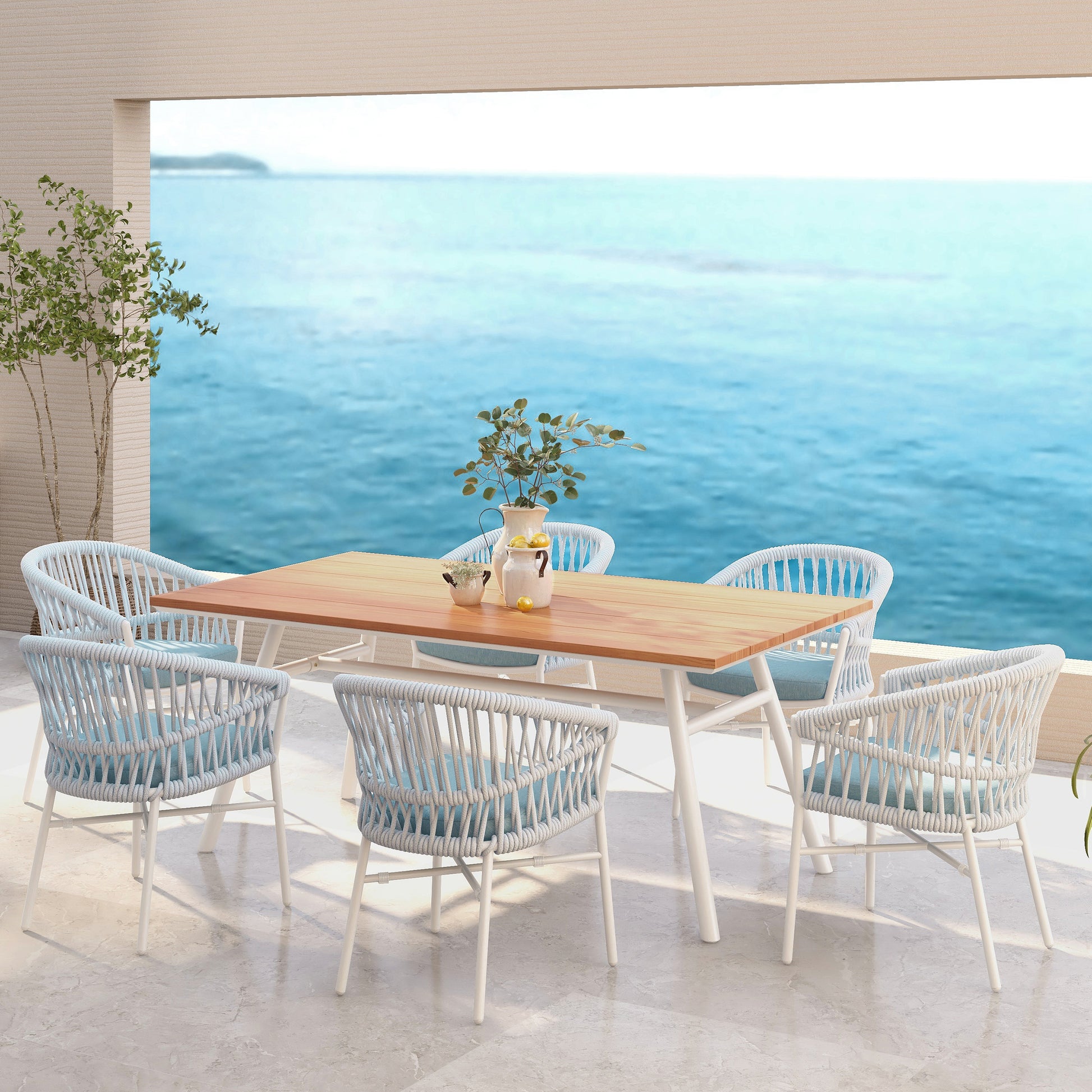 White ropewrapped patio chairs with light blue cushions surrounding a teaktop dining table
