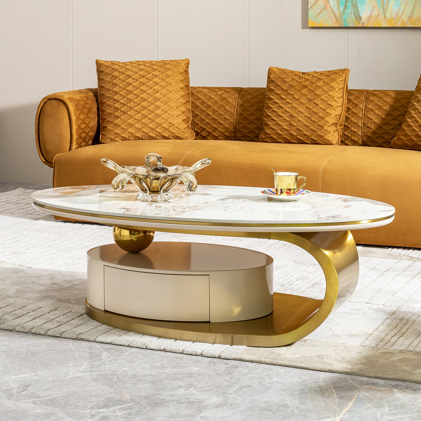 Oval marble coffee table with gold base and cream drawer