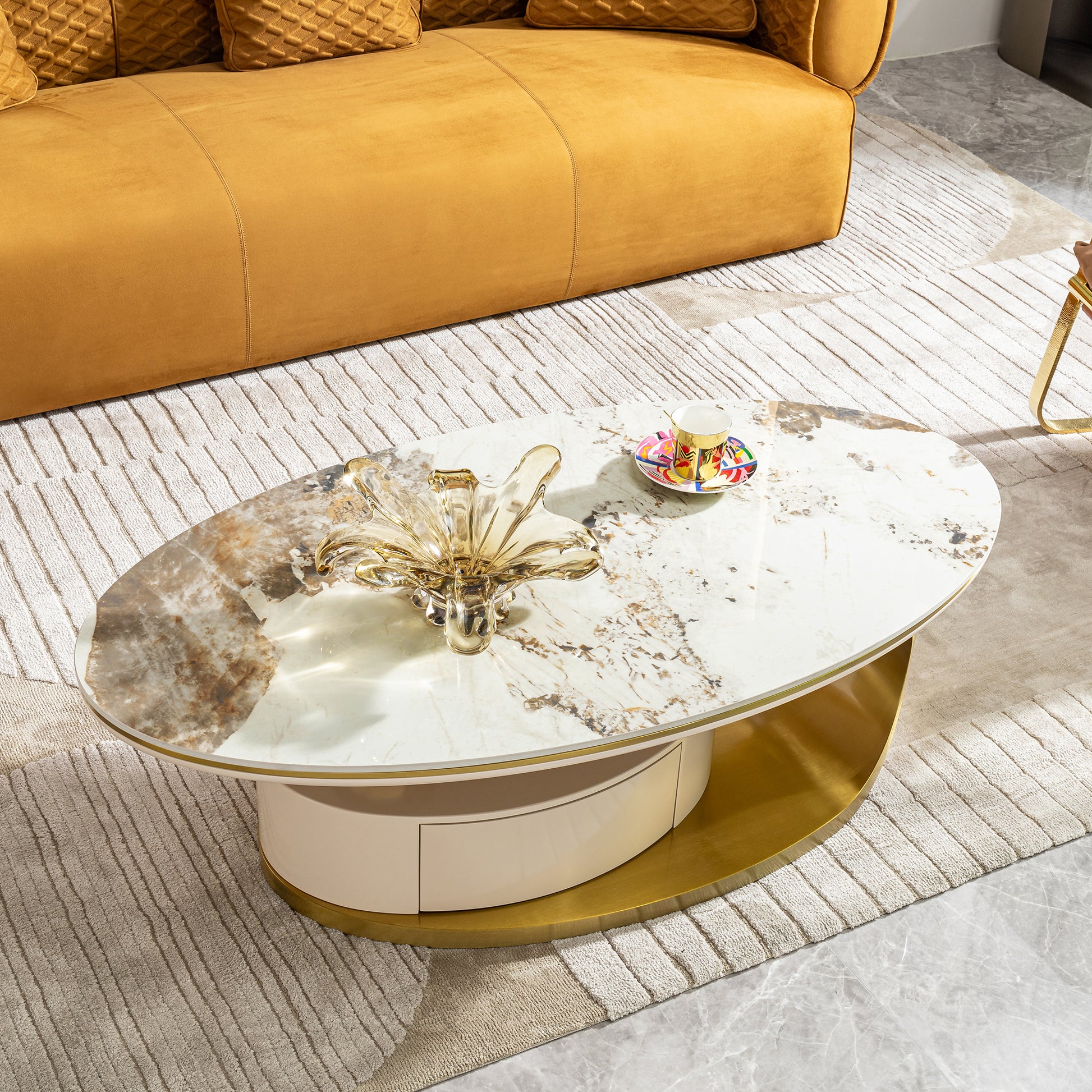 Oval marble coffee table with gold base and cream drawer