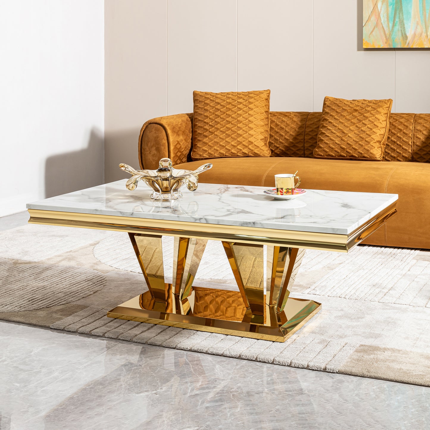 Modern marble coffee table with polished gold base and trim