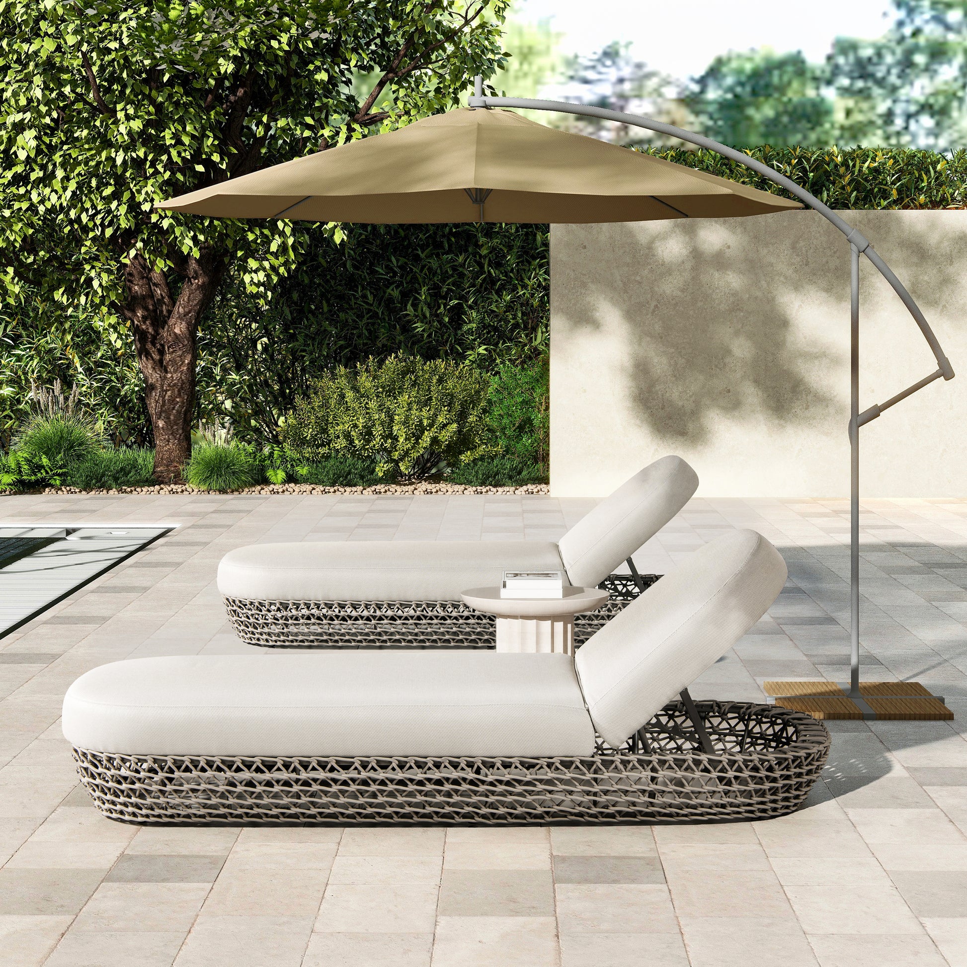 Two beige upholstered outdoor lounge chairs with woven bases on a stone patio