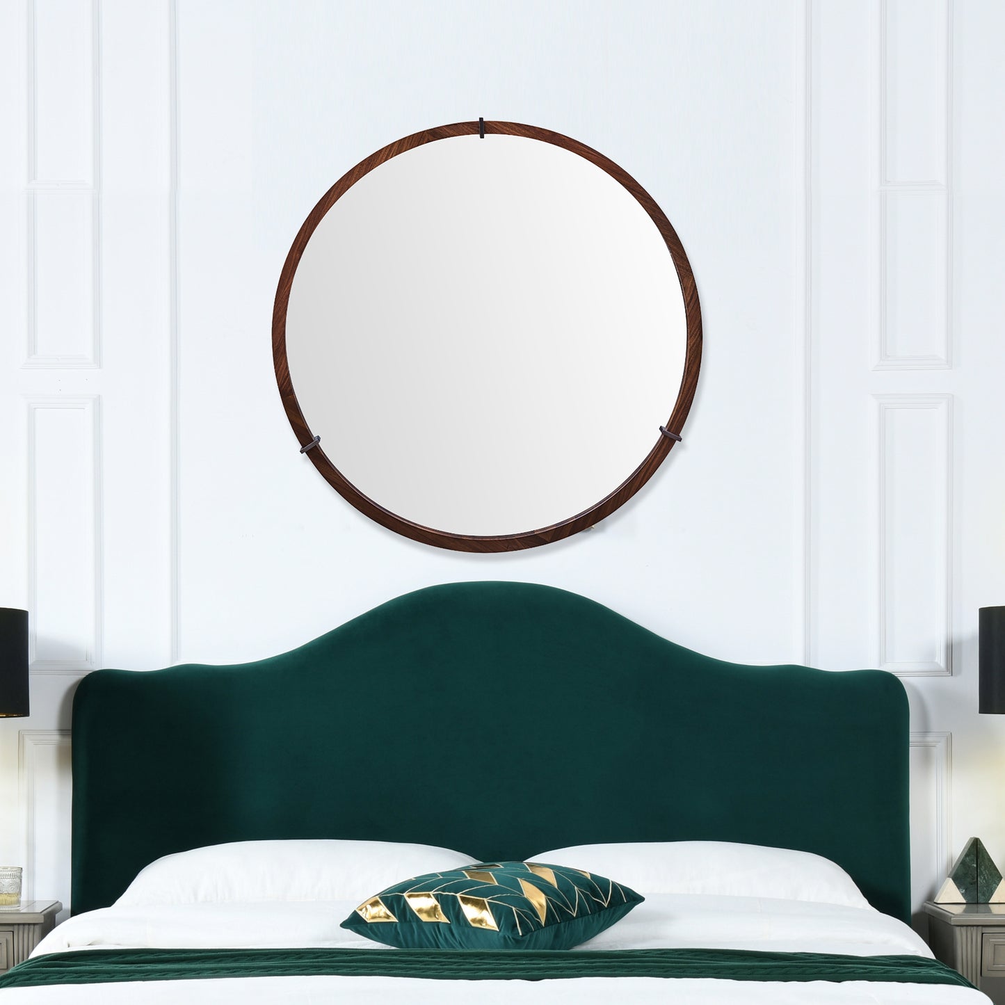 Round walnut wood framed mirror above a dark green velvet headboard Perfect bedroom decor
