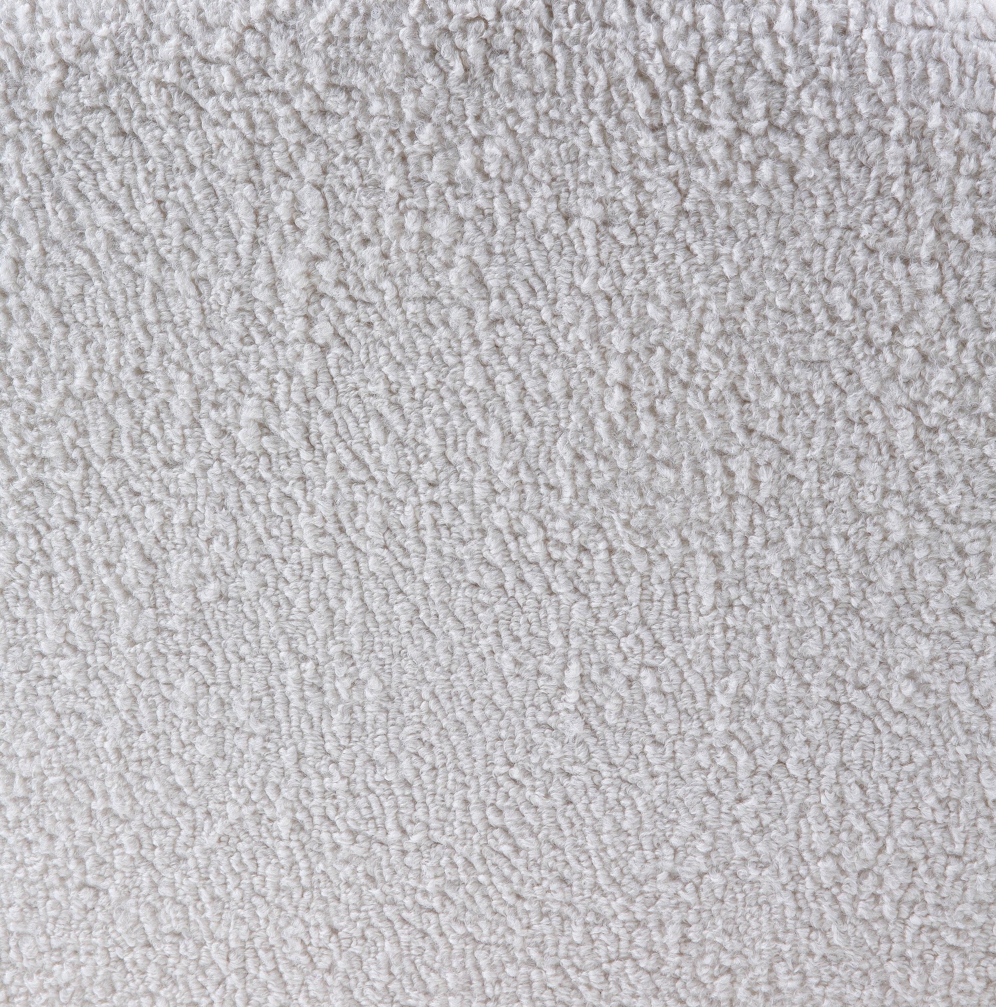 Closeup of a soft white sherpa fabric with a fluffy texture
