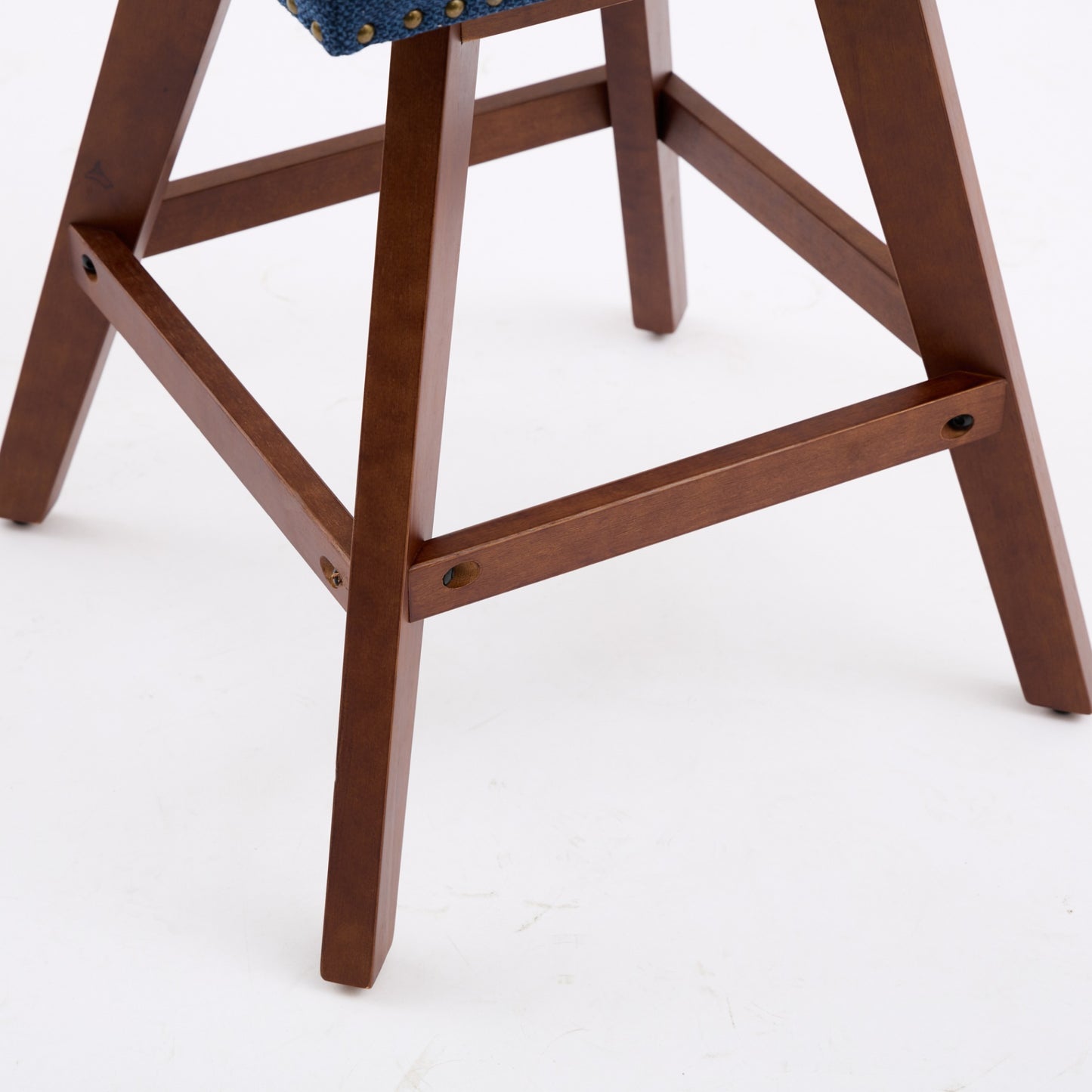 Dark wood bar stool frame with riveted blue fabric seat