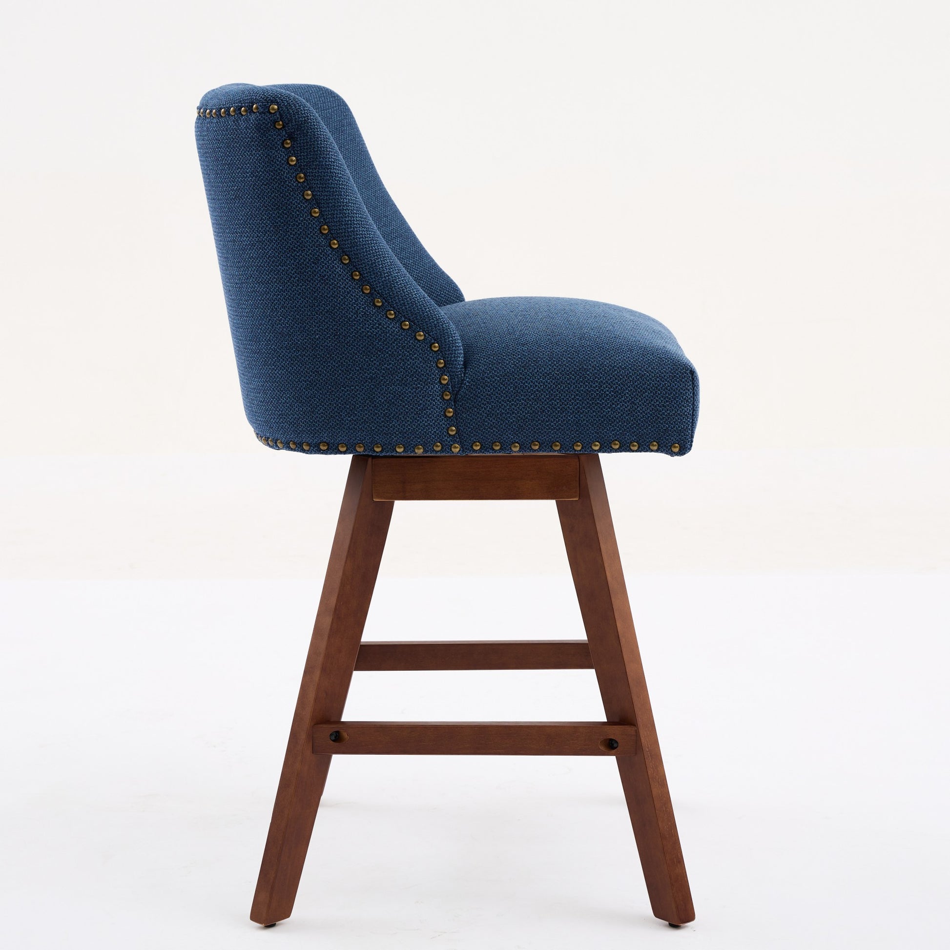 Navy blue upholstered swivel bar stool with wood legs and brass nailhead trim