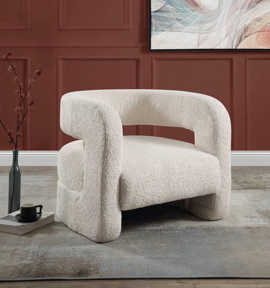 Cream boucl accent chair with curved arms and soft texture perfect for a cozy reading nook