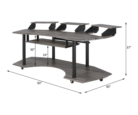Dark grey wood grain studio desk with multiple shelves and rolling casters