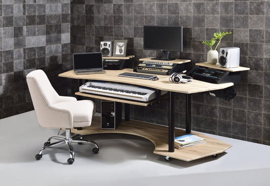 Ergonomic studio desk with integrated keyboard tray and computer storage in a light wood finish