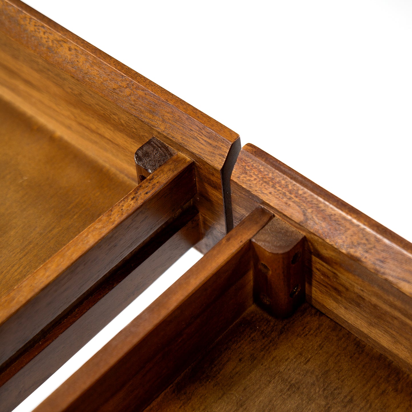 Closeup of rich brown wood joinery detail on a furniture piece