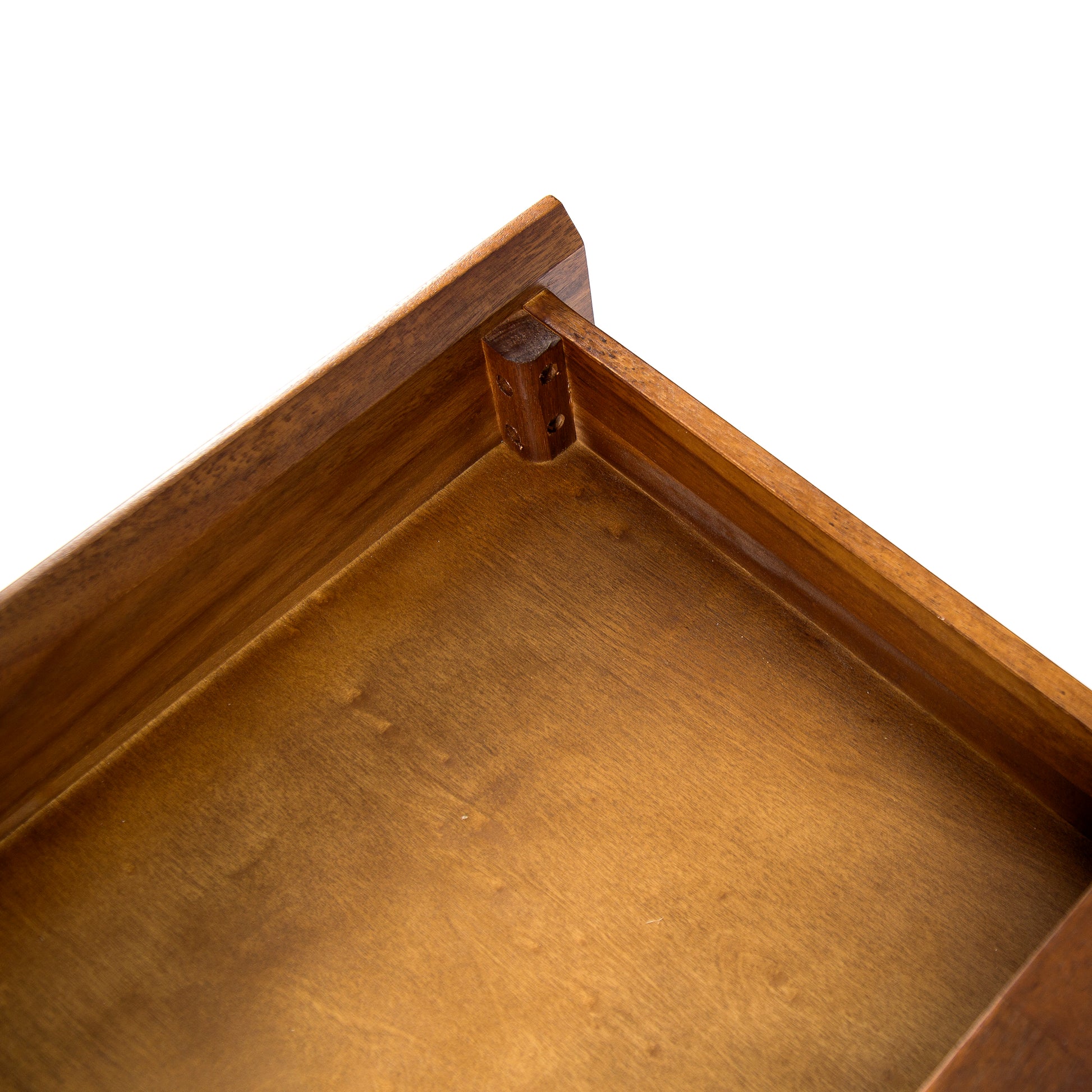 Rich walnut wood drawer interior with visible grain and corner joint detail