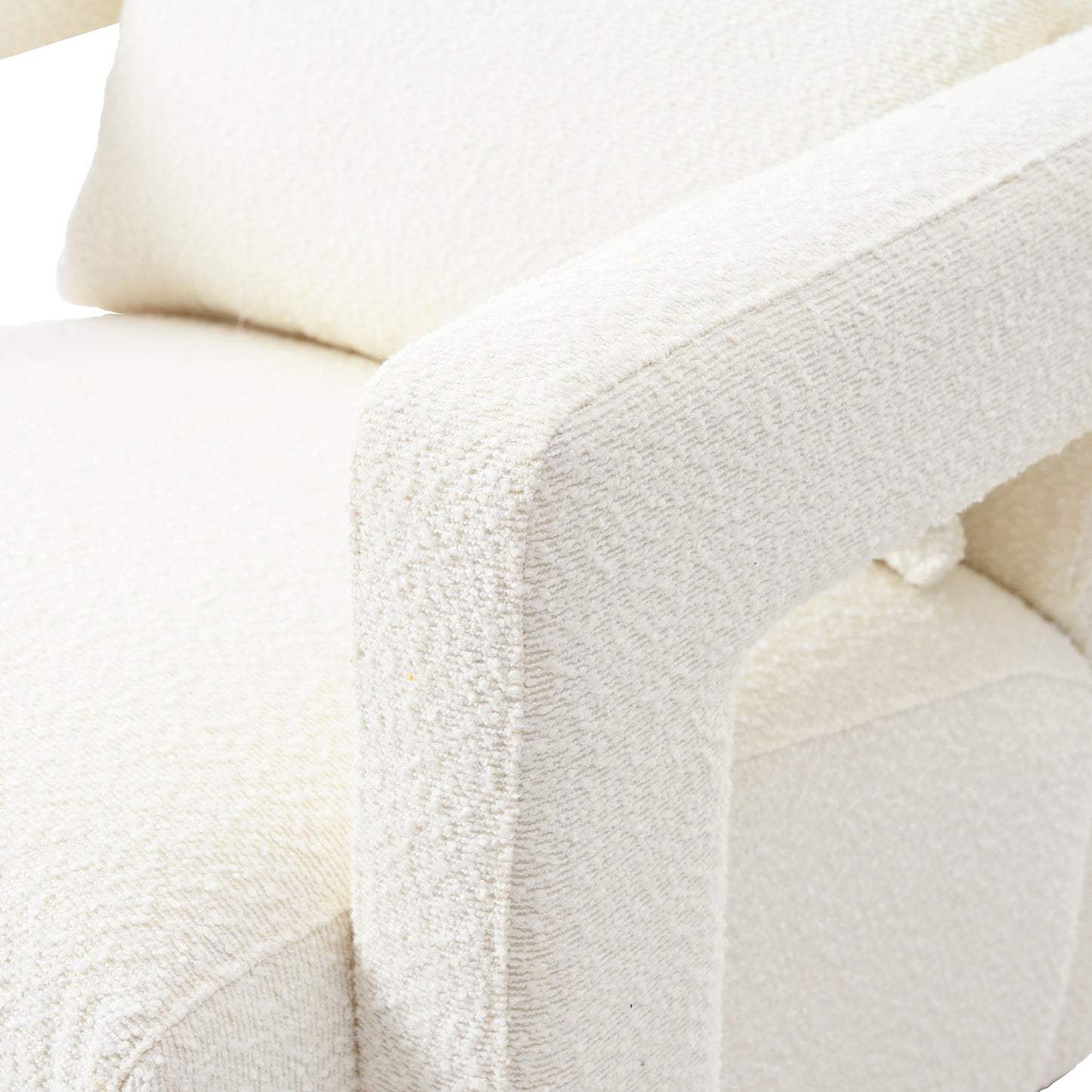 Closeup of a plush cream boucl armchair showcasing its textured fabric and comfortable design