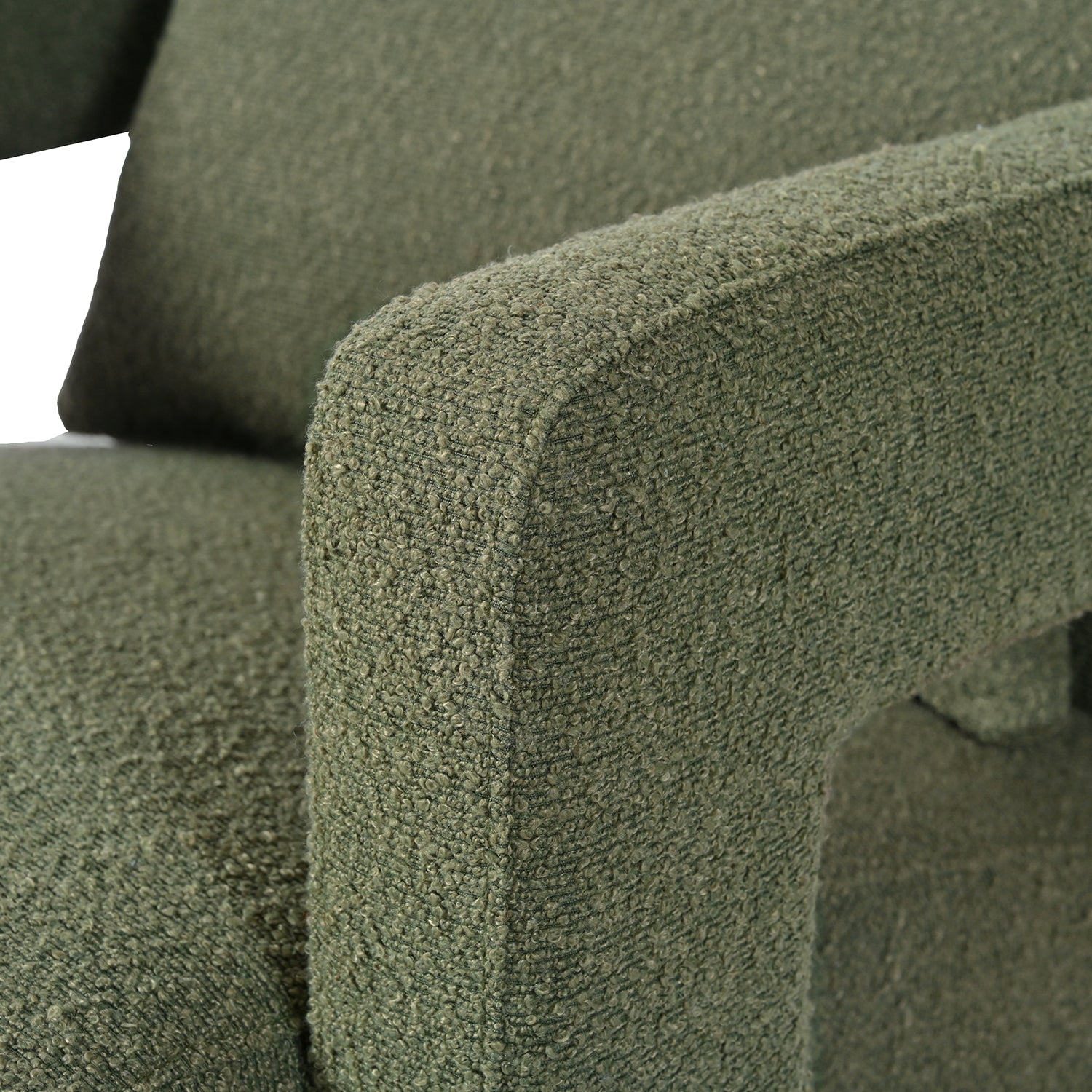 Closeup of a textured green armchair armrest with boucle fabric
